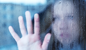 woman-looking-through-rainiy-window